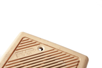 Old domestic smoke detector alarms on white background
