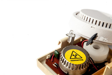 Old domestic smoke detector alarms on white background