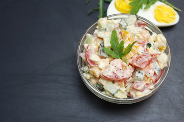 Vegetable Salad Bell Pepper, Tomato, Cucumber, Eggs and Mayonnaise. Health Vegan salad. Glass Bowl Black Board.