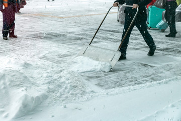 A man cleans the road from the snow.