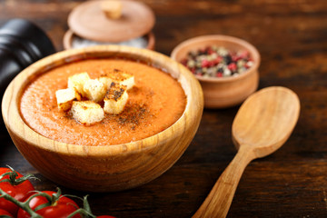 soup gazpacho on a wooden background in a wooden plate.