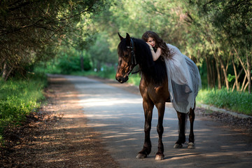 beautiful girl in a smart dress fell on a horse