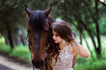 Obraz premium portrait of a beautiful girl in a smart dress with a horse