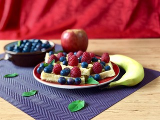 Fresh waffles with garden fruits