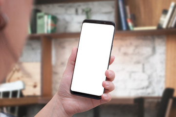 Woman holding smart phone with white isolated screen for mockup. Close up. Isometric view.