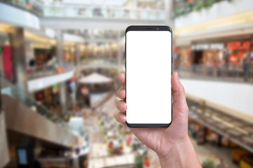Modern mobile phone with round edges in woman hand. Bussiness city center in background.