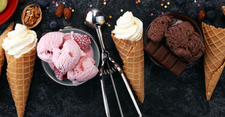 Vanilla frozen yogurt or soft ice cream in waffle cone in various flavour