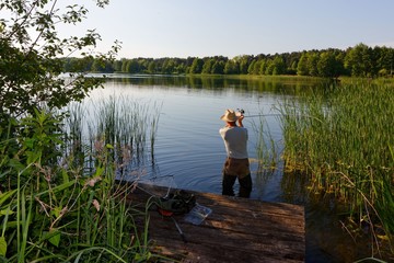 fisherman catching the fish durring sunny day