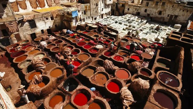 Chouwara traditional leather tannery in Old Fez, vats for tanning and dyeing leather hides and skins, Fez, Morocco, North Africa, T/Lapse