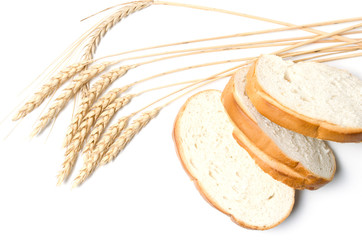 Slices of sliced bread and wheat on white background.