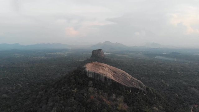Cinematic aerial over pidurangala and sigiriya rock at sunset, two of the most famous places of Sri Lanka. Shot in 4k.