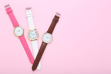 Wrist watches on pink background