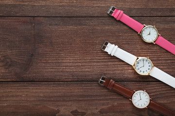 Wrist watches on brown wooden table