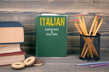 Italian language and culture concept. Book on a wooden background