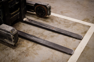 Forklift doing work in the warehouse on loading area background