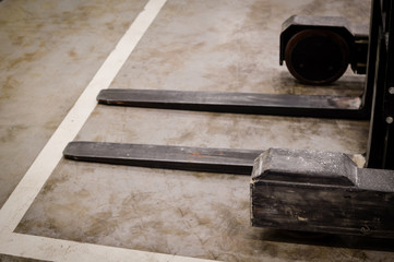 Forklift doing work in the warehouse on loading area background