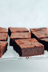 Chocolate brownie square pieces. American traditional delicious dessert. Close up photography.
