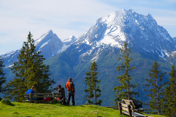 Fototapeta na wymiar A group of people hiking with beautiful panorama of Watzmann near Berchtesgaden, Germany