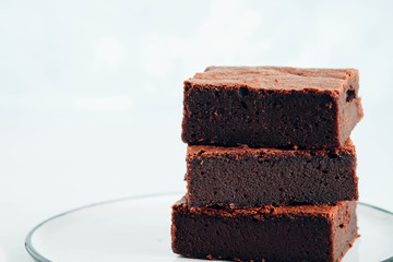 Chocolate brownie square pieces. American traditional delicious dessert. Close up photography.