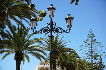 Fototapeta na wymiar Artfully forged lantern on a public square in Andalusia, Spain 