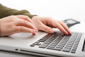 Laptop with woman hand isolated