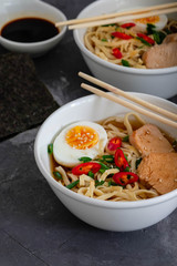 Traditional Japanese soup ramen with meat broth, asian noodles, seaweed, sliced chiken, eggs. Close up. Asian style food. Top view. Hot tasty ramen soup for dinner.