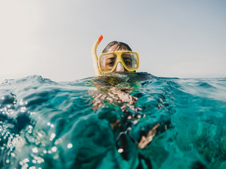 Lovely woman doing snorkeling at the gili islands in Indonesia. Wearing yellow glasses at the blue sea. Travel photography, lifestyle. - obrazy, fototapety, plakaty