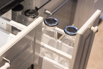 Modern kitchen top with food ingredients. Top view of drawer with glass jars