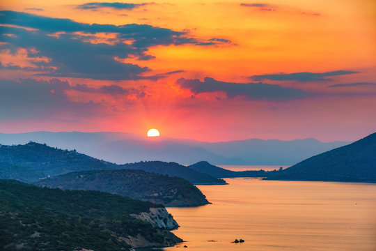 Fototapeta Colorful sunset over sea in Greece