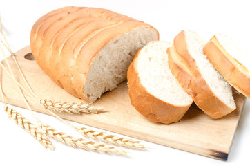 Slices of sliced bread and wheat on white background.