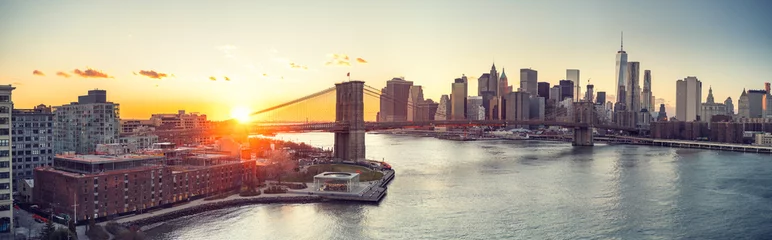 Poster Panoramisch uitzicht op de Brooklyn bridge en Manhattan bij zonsondergang, New York City © sborisov