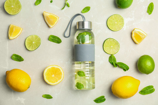 Flat lay composition with delicious natural lemonade on light background