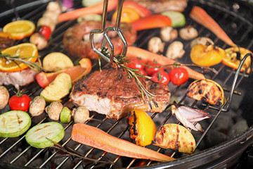 Cooking delicious meat and vegetables on barbecue grill, closeup