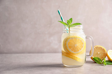 Fototapeta premium Refreshing natural lemonade in mason jar on table