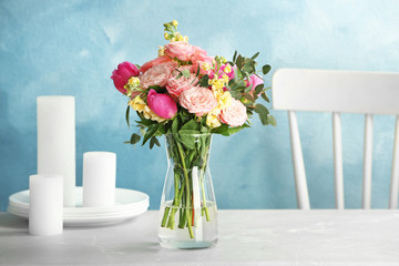 Vase with bouquet of beautiful flowers on table