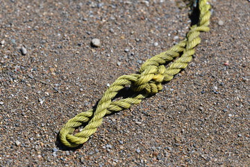 An old rope of a sailing ship stranded at the beach