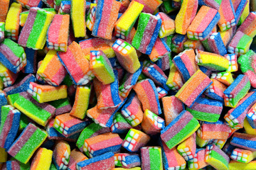 Fototapeta na wymiar long rainbow shape bright sugar marmalade candy flavor fruit, colorful jelly sweet close-up, candy background.