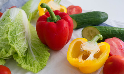 Vegetables isolated, red pepper, yellow pepper, tomatoes, cucumber and cabbage, bright food background