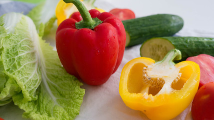 Vegetables isolated, red pepper, yellow pepper, tomatoes, cucumber and cabbage, bright food background