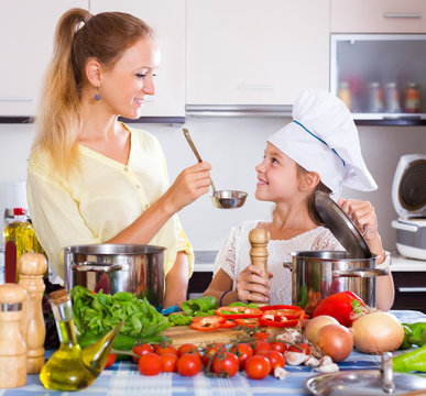 Mother and little girl cooking