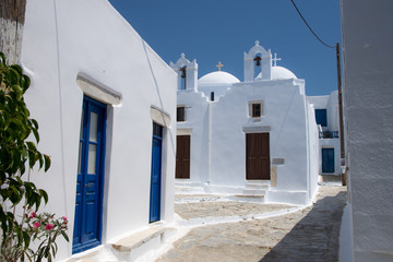 Amorgos,Greece-August 4 ,2017.Traditional wooden multi colored doors and a white stone walls in Amorgos