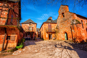 Fototapeta na wymiar Collonges-la-Rouge, red brick chruch and houses of the Old Town, France