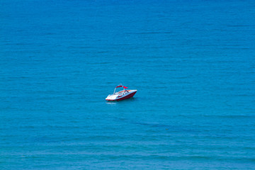 Obraz premium Beautiful blue sea and boats and beach resort huts from al hamra beach view