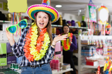 Happy girl standing in carnival outfits at holiday store