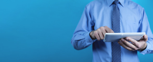 Businessman using white digital tablet. Concept of new technology