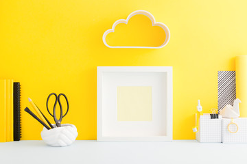 Creative desk with cloud over photo frame, mock up.