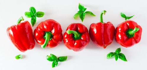banner group of red ripe organic bell pepper and fresh basil leaves isolated on white