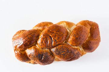 braided bread sprinkled with poppy seeds, isolated on white. copy space