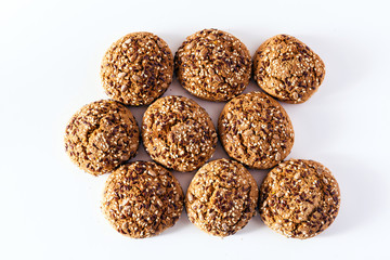 freshly baked oatmeal cookies sprinkled with sunflower seeds, linseed and sesame seeds. healthy pastries on a white background
