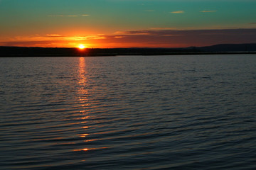 Sunset over the surface of the water